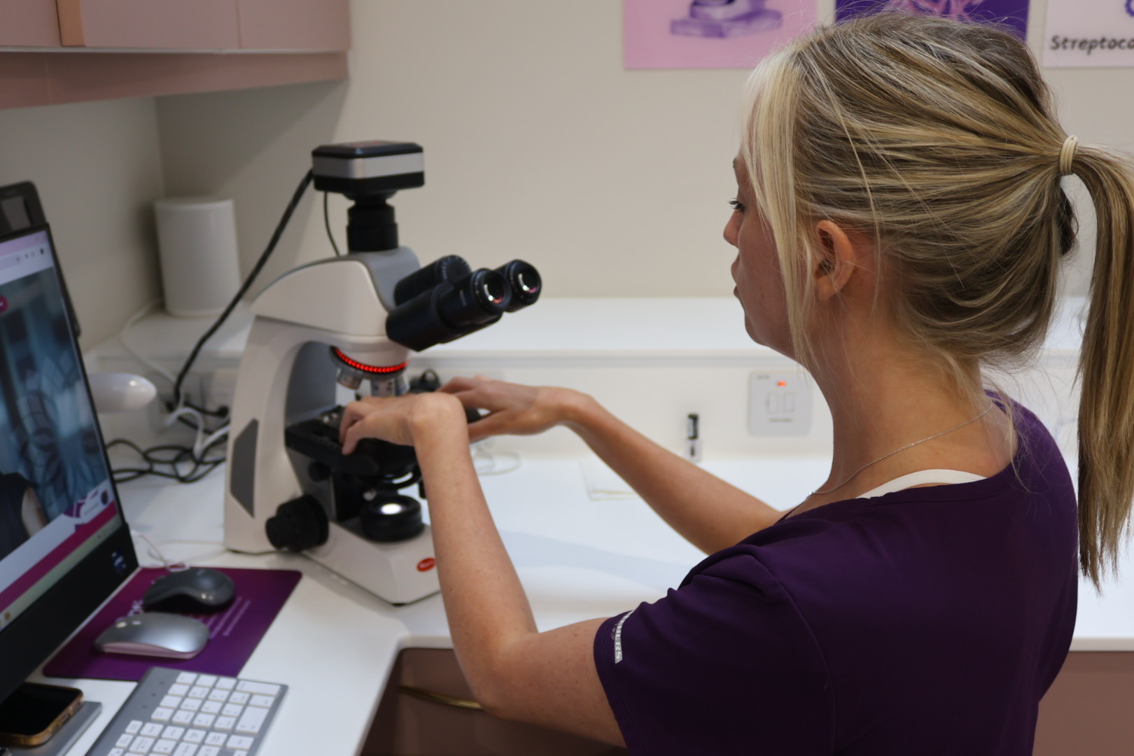 an image of dental hygienist brooke shipp looking into the phase contrast microscope at optimal dental health