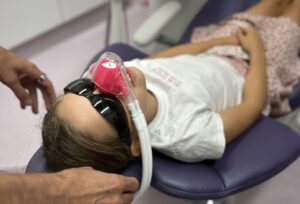 image of child sitting in a dental chair waiting for inhalation sedation