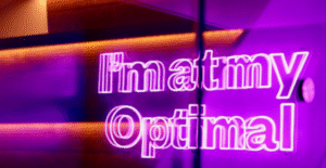 a neon sign saying im at my optimal, located in optimal dental health baker street