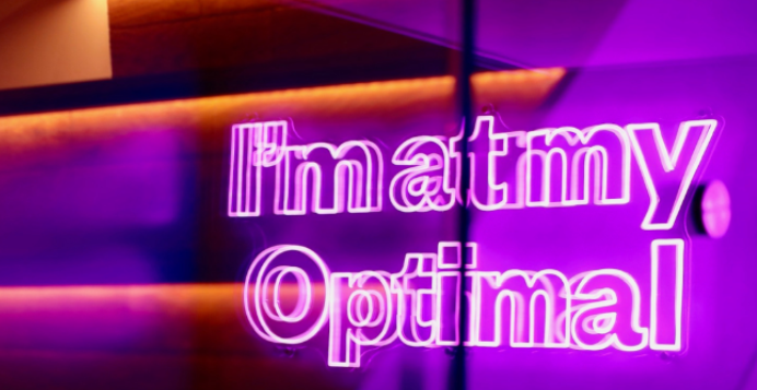 a neon sign saying im at my optimal, located in optimal dental health baker street