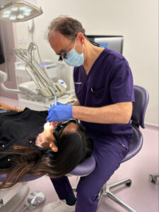 an image of dr james goolnik biological dentist in london with a patient for a dental health check in baker street 