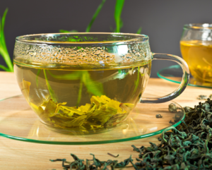 a photo of a glass mug of green tea and oral health benefits