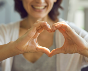 two hands held infront of the camera to form a heart shape to signify heart health and longevity 